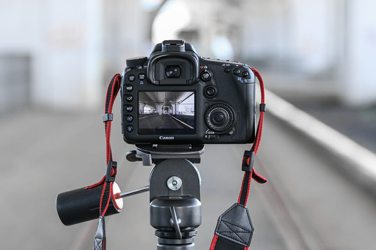 view of camera screen on tripod red strap sharp photographs