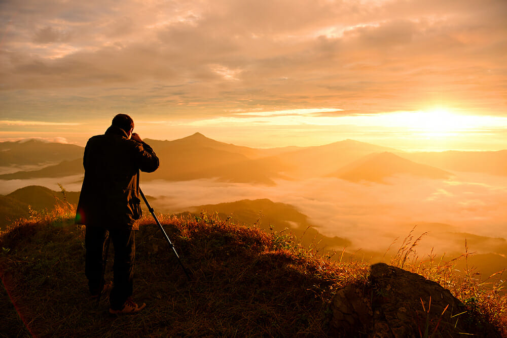 photographer view point landscape sunset sun orange yellow mountains hills