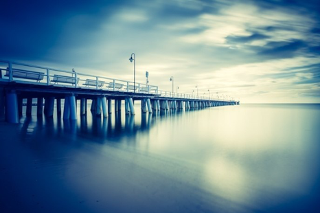 pier beach blue yellow water calm shutter speed slow