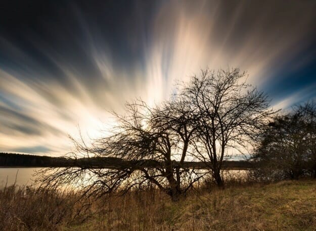 lake water tree branch cloud smooth water slow shutter speed