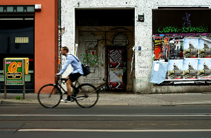street photography portrait city people camera subject light how to tutorial guide man riding bike blur motion movement street