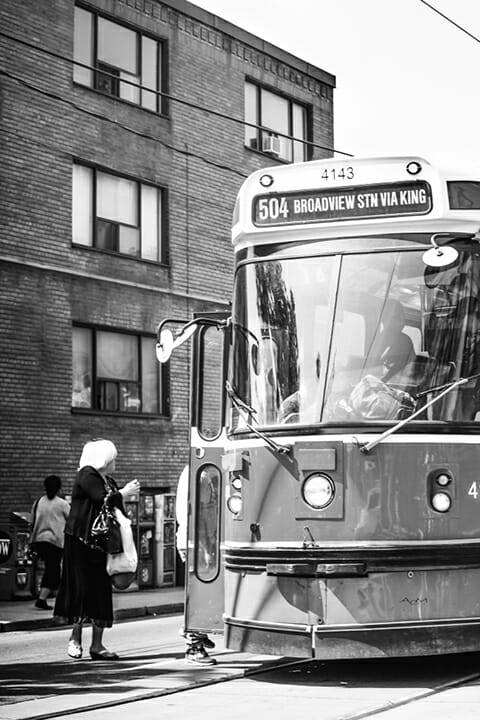 black and white tram in town lady walking near street photography portrait city people camera subject light how to tutorial guide