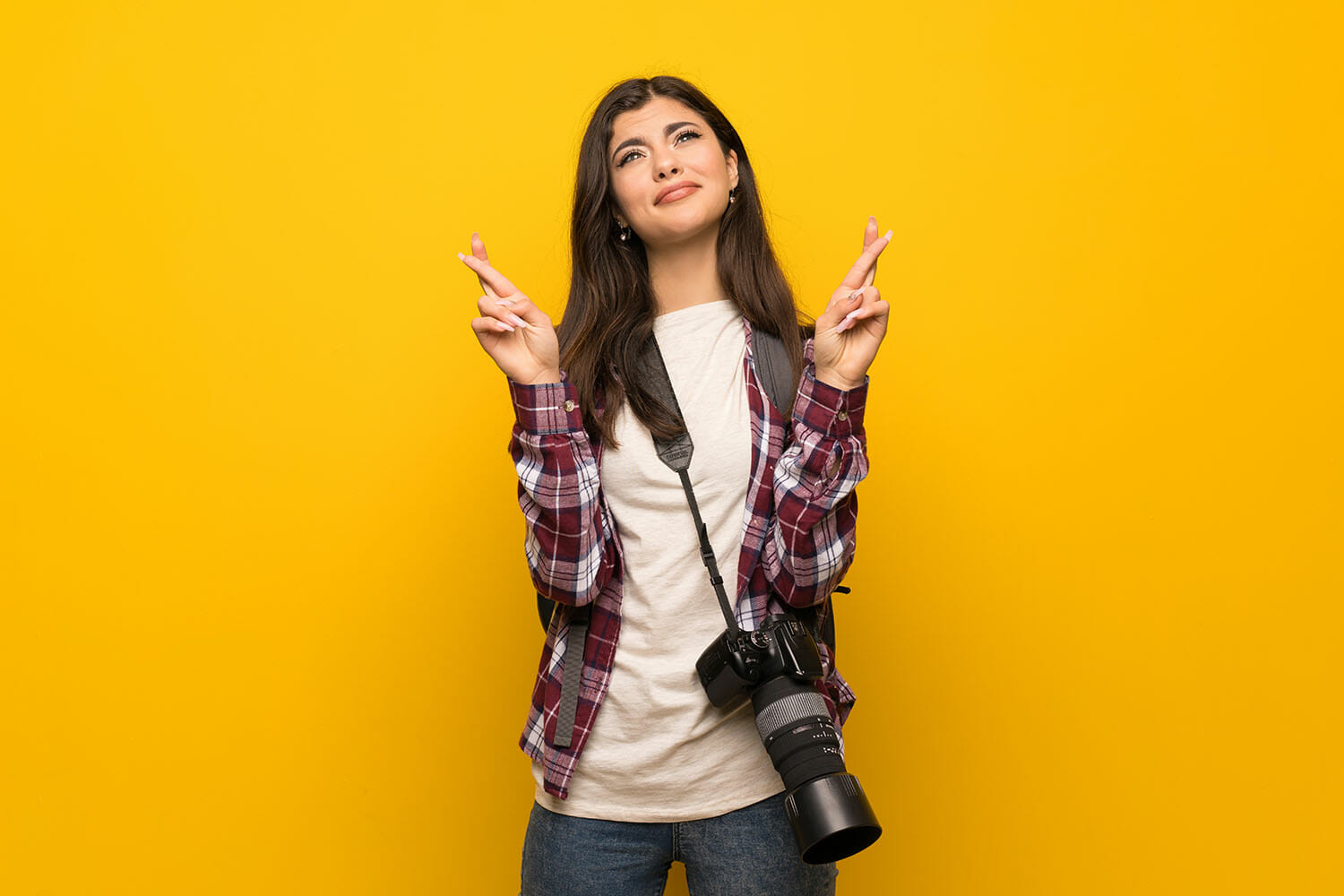 fingers crossed model on yellow