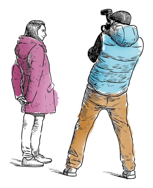 man taking photograph of lady in the street