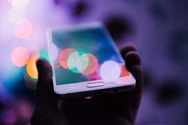smartphone under bokeh lights