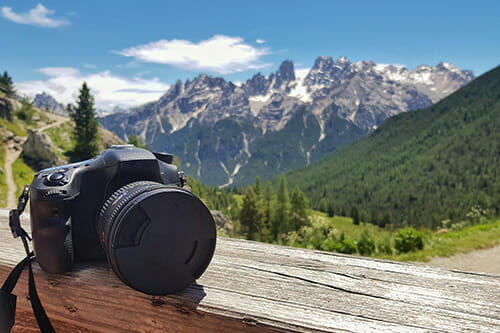 camera on ledge mountains in background landscape photography