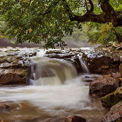 water slow shutter speed over rocks on river landscape photography