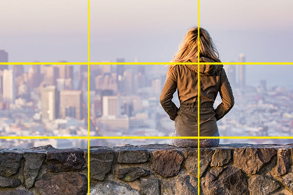 female sat on wall overlooking city
