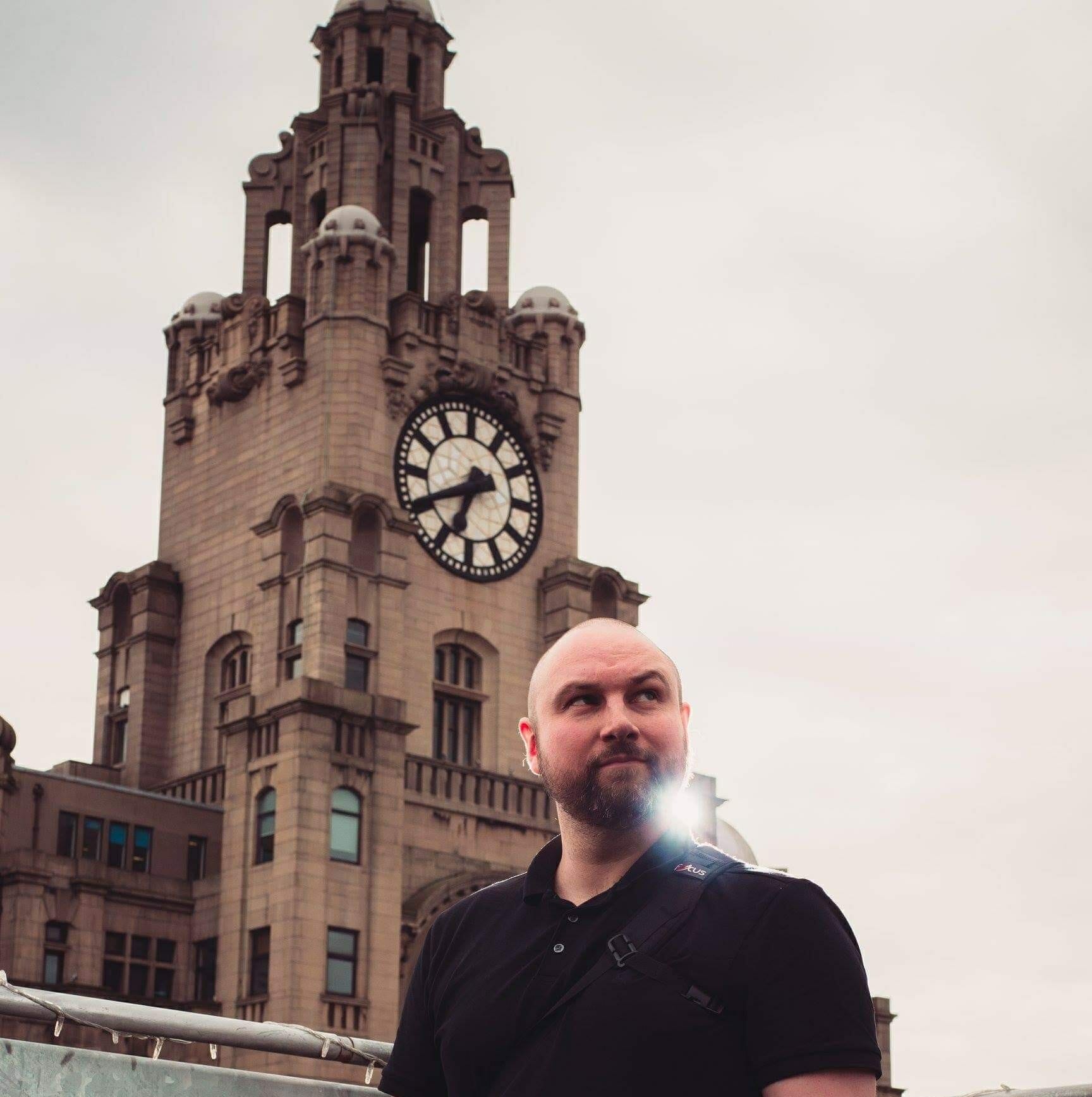 62147780_10156172644481720_5964424047482634240_o a wedding photographer standing infront of the liver buildings