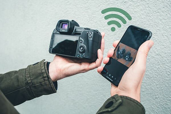 5. wifi what camera is best iphotography man with camera connecting phone via wifi