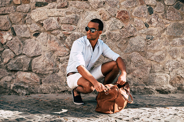 posing men blog image man wearing sunglasses looking in a bag crouched down posing men blog image man wearing sunglasses looking in a bag crouched down