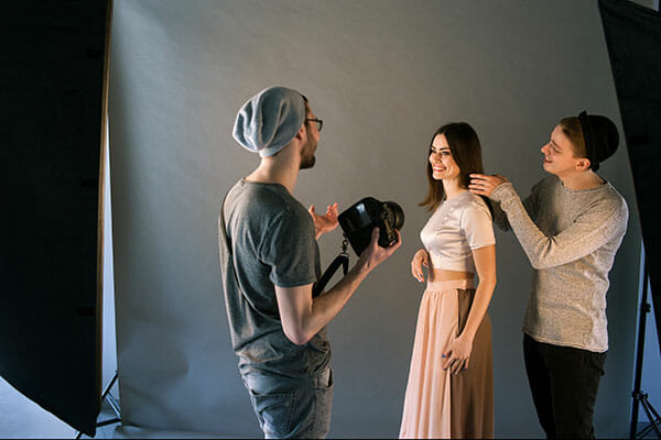 Creative,Fashion,Team,Work,With,Model,In,Studio.,Professional,Stylist Creative fashion team work with model in studio. working with models Professional stylist and photographer communicate with cheerful woman on photoshoot