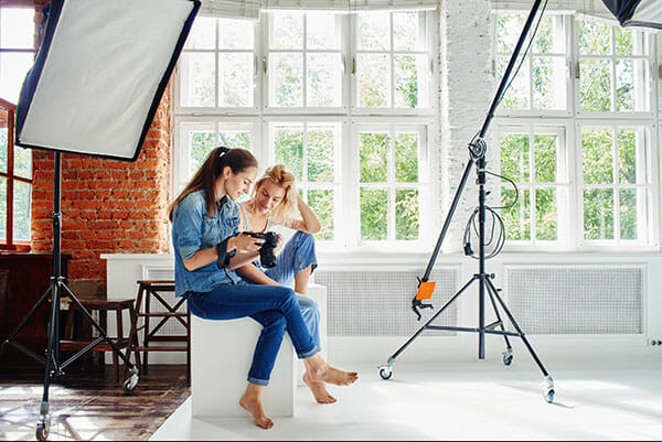 Girl,Photographer,Shows,The,Picture,Of,The,Model Girl photographer shows the picture of the model working with models