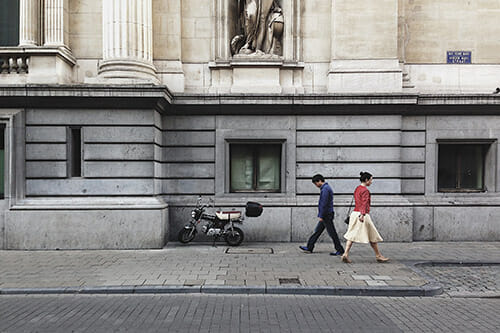 two people walking opposite direction street think outside the box