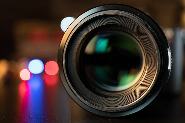 The,Photo,Or,Videocamera,Lens,On,Dark,Background,With,Lense Use your widest aperture