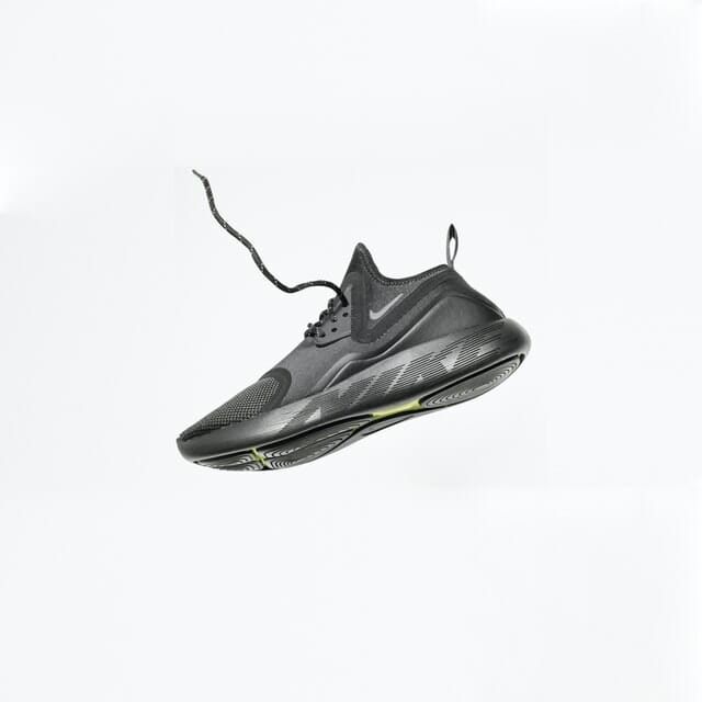 1 black trainer floating on white background