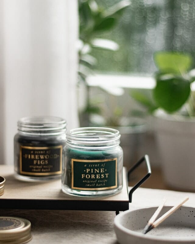 Candles how to do product photography two green candles sat by a window