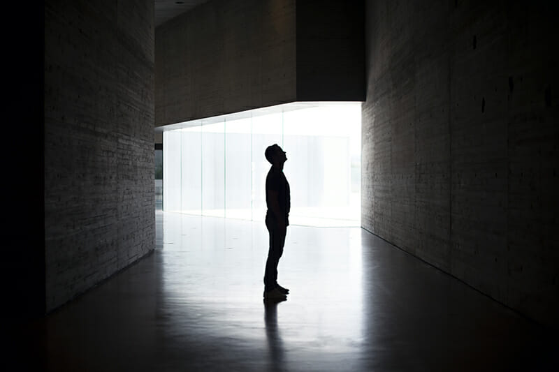 Lonely,Silhouette,In,Dark,Architecture,With,Light,Background.,Horizontal,Image.