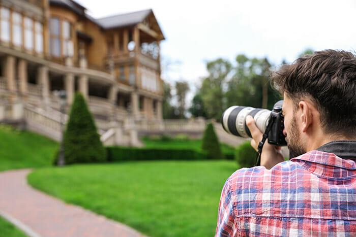 Photographer,Taking,Photo,Of,Beautiful,House,With,Professional,Camera,Outdoors Real Estate Photography Guide by iPhotography Image 2