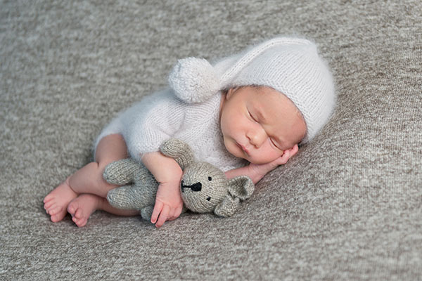 Newborn,Boy,Sleeping,In,Funny,Bonnet