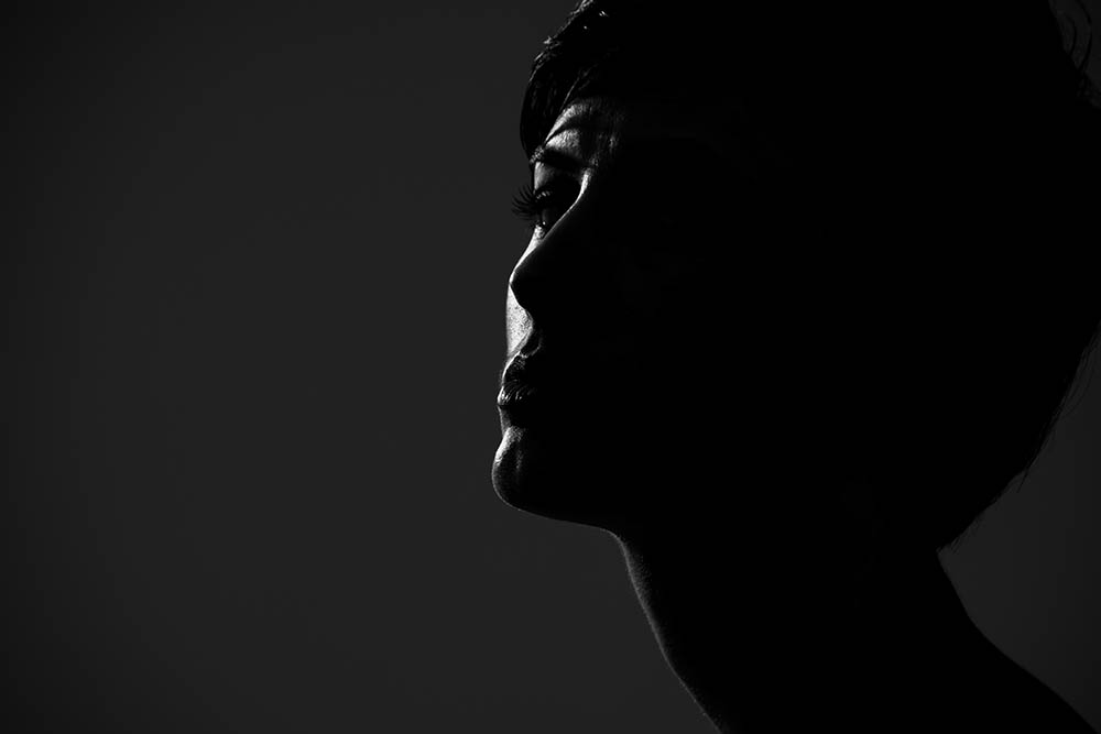 Abstract,Silhouette,Portrait,Of,Short,Hair,Woman,Looking,At,Camera low light portraits example