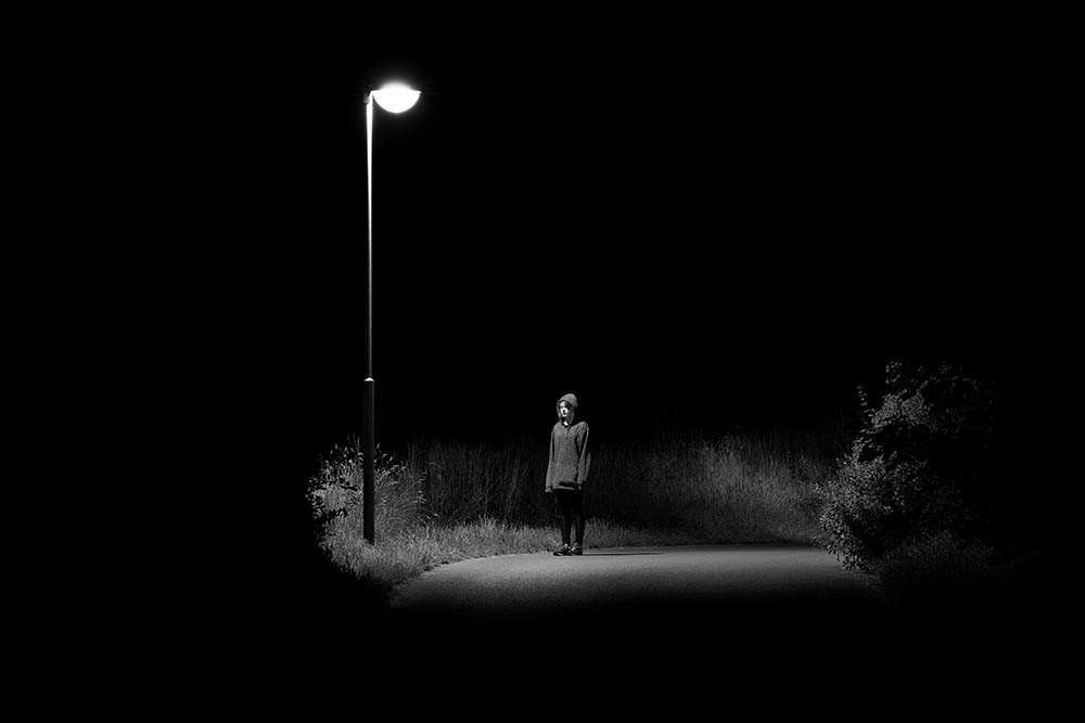 Sad,Woman,Standing,On,A,Lonely,Night,Street,Corner