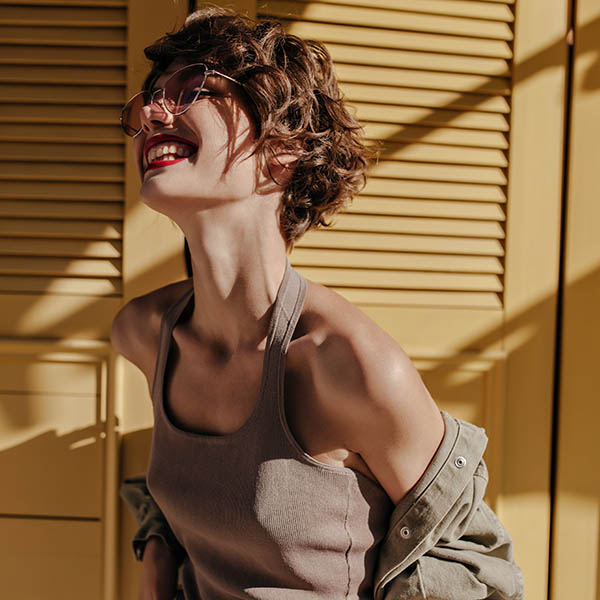 Joyful,Lady,In,Undershirt,And,Jeans,With,Belt,Laughing,On female portrait 1